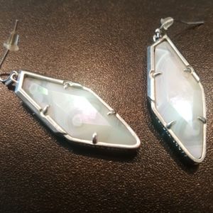 Iridescent Kendra Scott Bexley drop earrings.